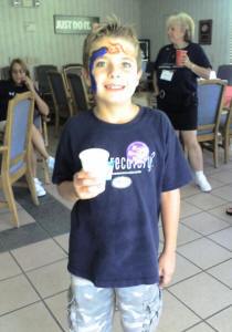 Zach demonstrating face-painting