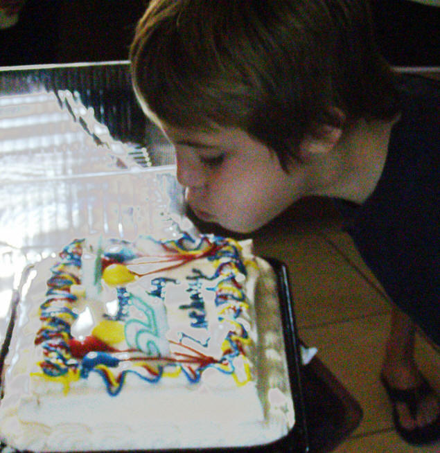 Zach blows out his candles.