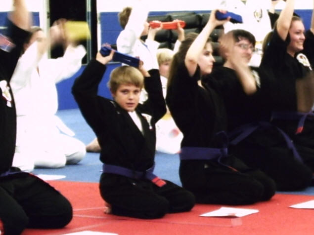 Zach's Blue Belt raised in triumph.