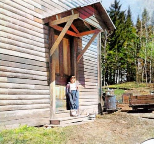 Mary Joan beneath new front entrance roof. You can see the clapboards that replaced rotted boards.
