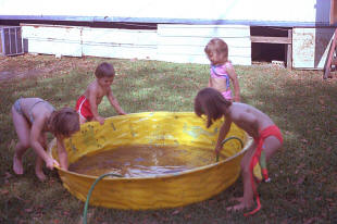 Rinsing sand off the pool.