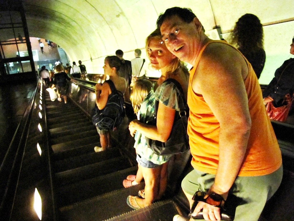 Dottie, Cailey, Karen and Michael ride the escalator.