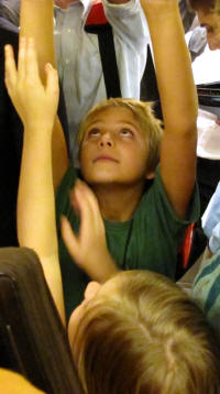 Zach and Cailey reach for air on the crowded subway.