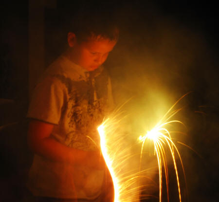 Zachary Dylan with two sparklers.