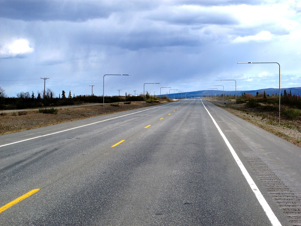 Poles mark the road boundaries in winter.