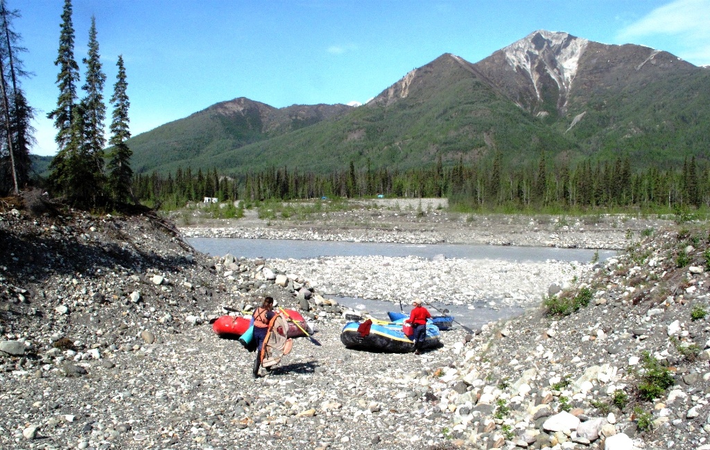 Gaia and Danny prepare the rafts at the Kennicott River's edge.