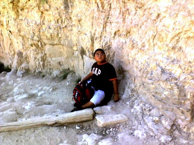 Chris sits safely on the ground.