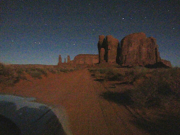 The road through Monument Valley by moonlight.