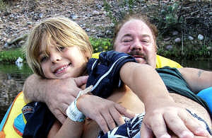 Zachary and Big Papa share a float.