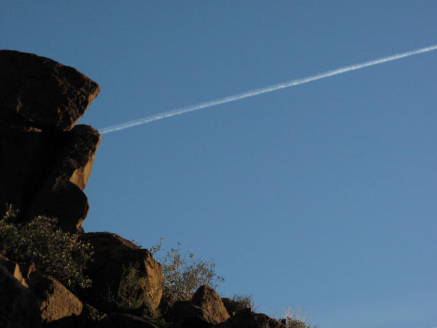 Jet contrail over the wall of the Superstition Mountains.