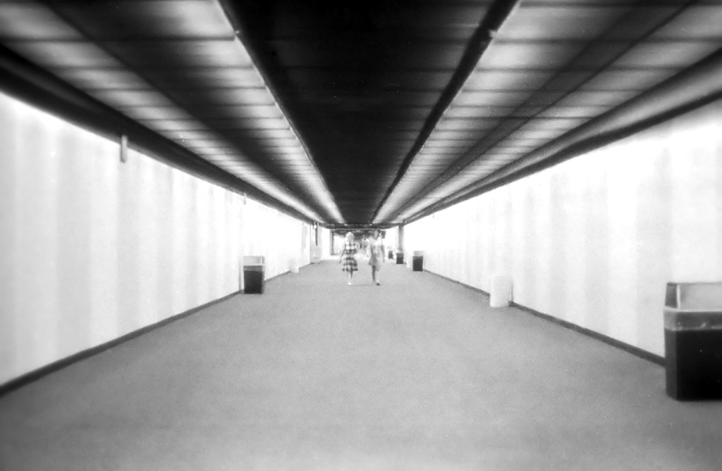 Mom and Mary Joan walking down the long hall at JAX, 1970.