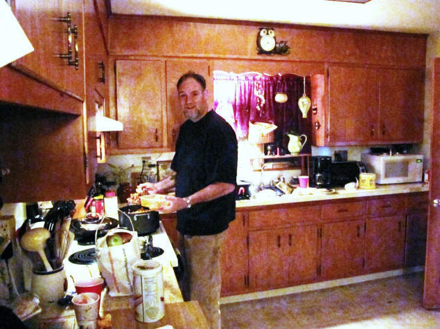 Wayne cooks lunch.