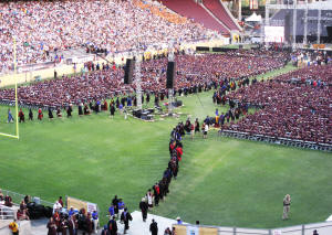 The faculty parades across the field.